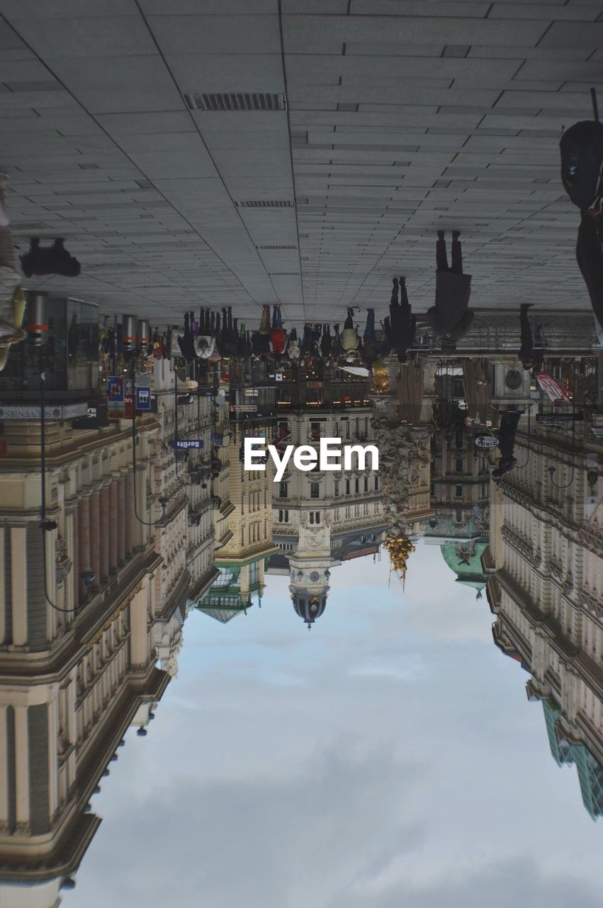 Upside down image of people walking on street in city