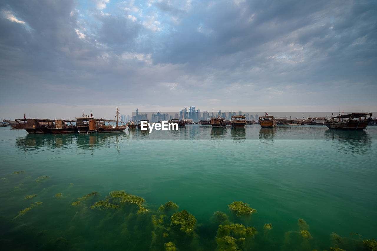 Boats in sea against sky