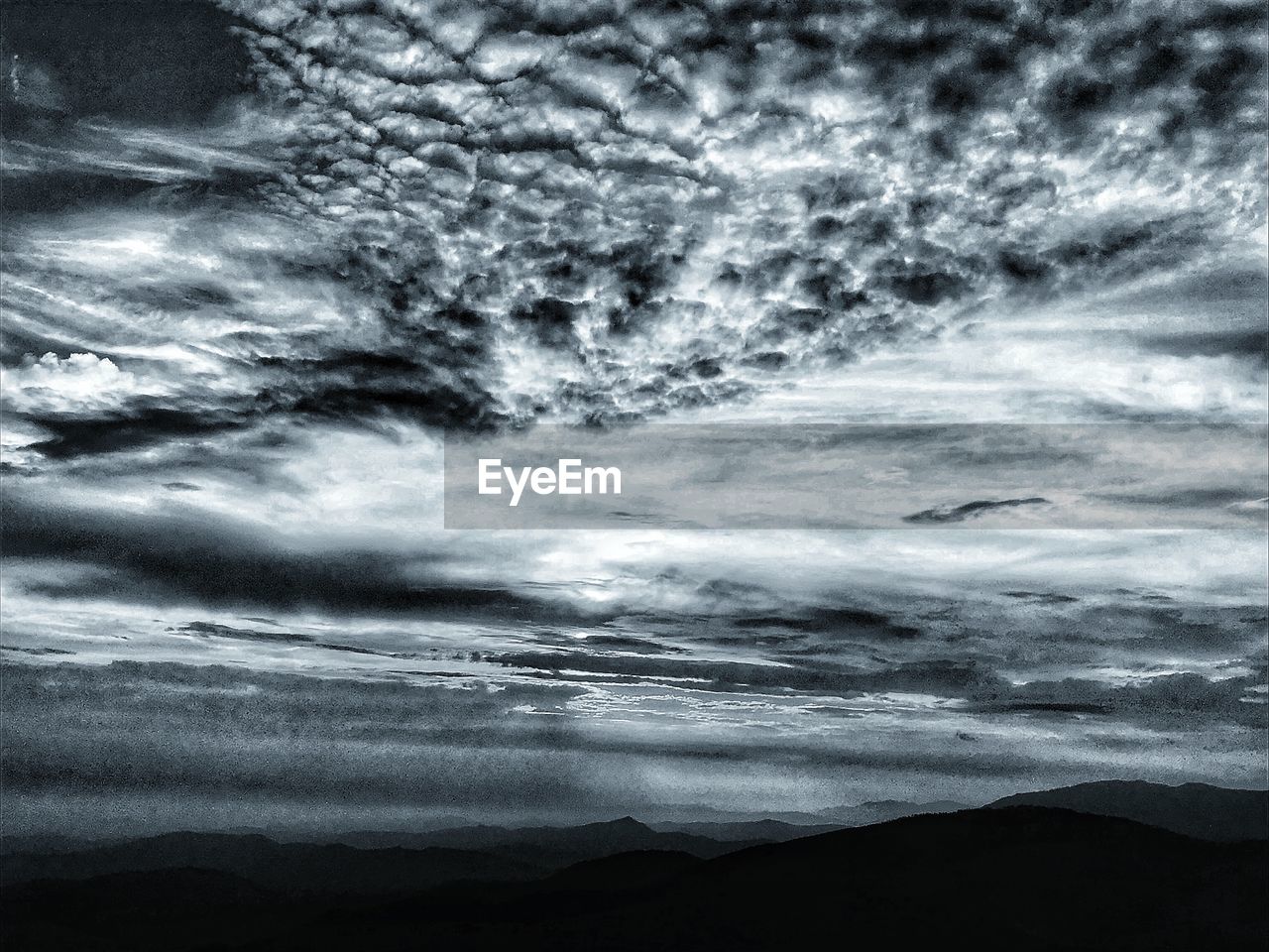 SCENIC VIEW OF CLOUDS OVER MOUNTAIN