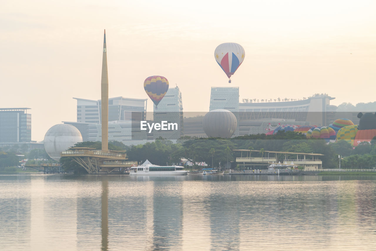 HOT AIR BALLOONS FLYING OVER RIVER