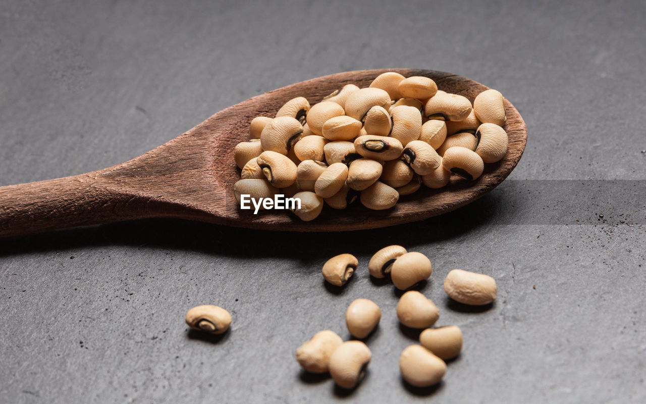 Close up of coffee beans with coffee powder as background