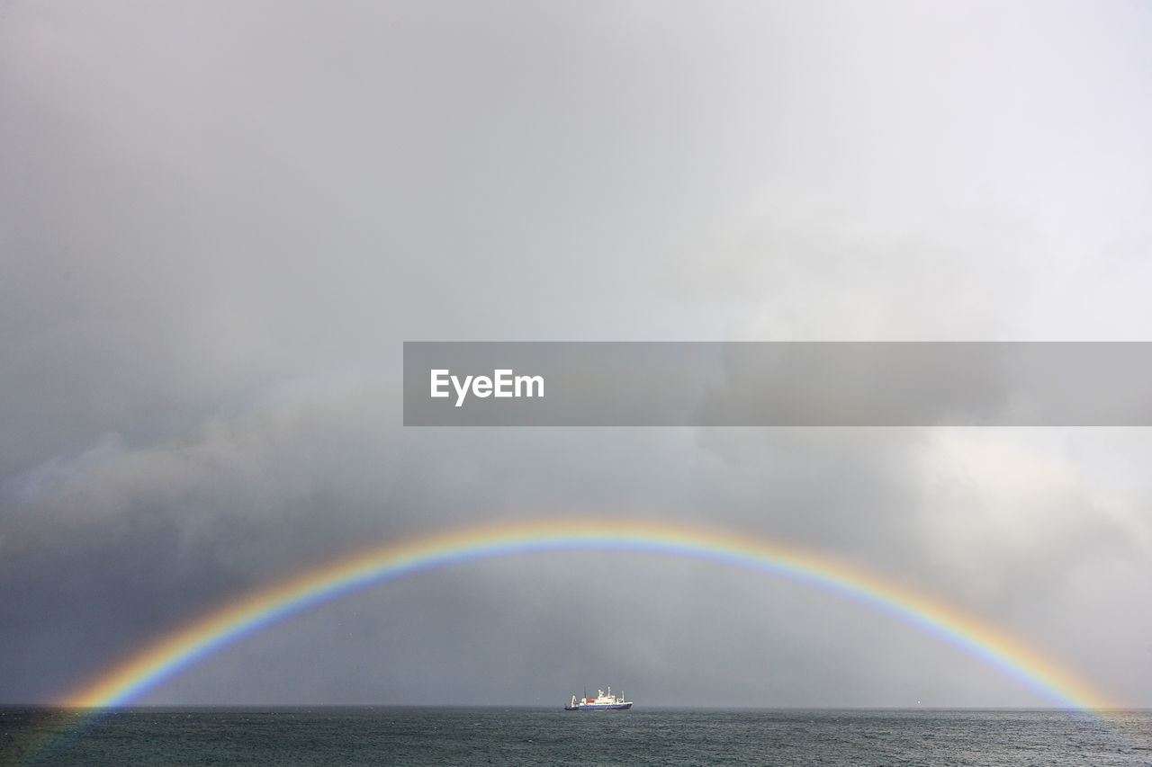 Rainbow over sea against sky