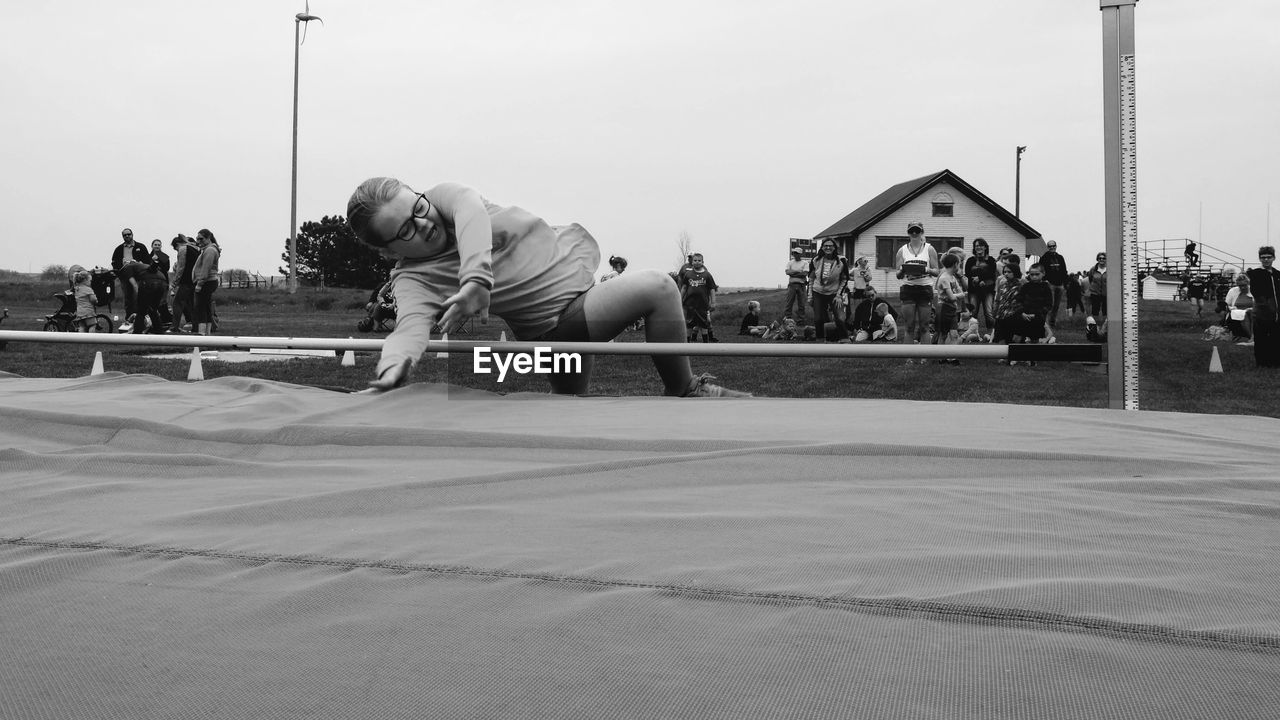 PEOPLE IN PARK AGAINST SKY