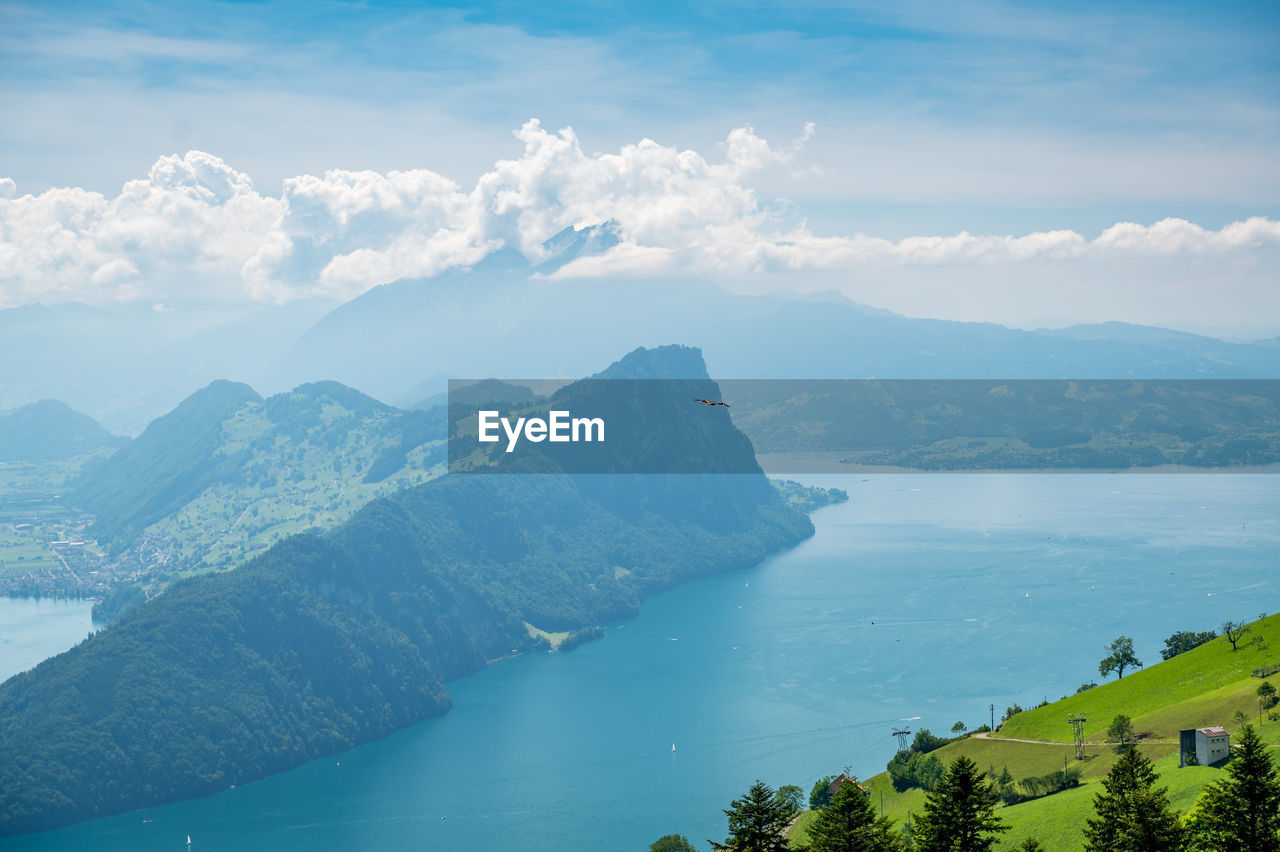 Scenic view of sea and mountains against sky