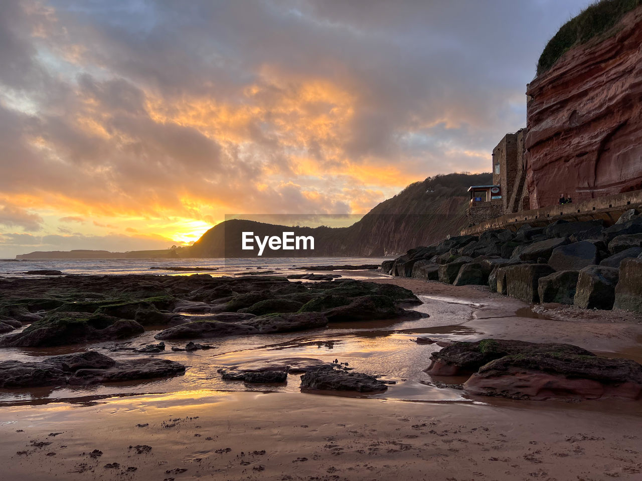 sky, coast, water, land, sunset, sea, rock, environment, cloud, nature, landscape, scenics - nature, beauty in nature, beach, travel destinations, shore, ocean, travel, dramatic sky, no people, wave, dawn, outdoors, tourism, seascape, sand, mountain, sun, evening, tranquility, body of water, architecture, horizon, cliff, coastline, bay, holiday, rock formation, trip, reflection, vacation