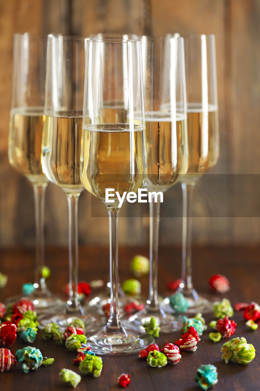 CLOSE-UP OF WINE GLASSES ON GLASS TABLE