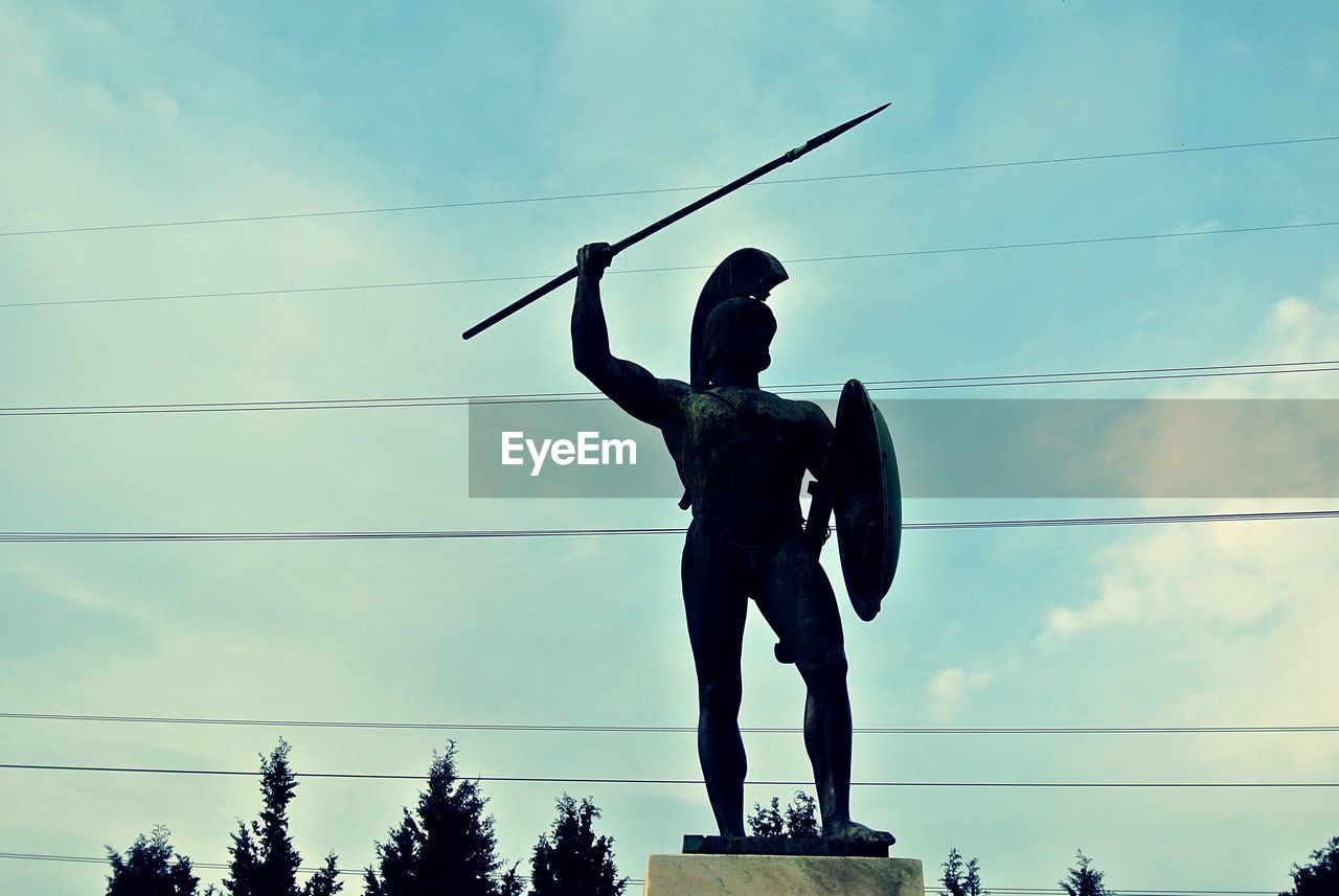 Low angle view of leonidas statue against sky