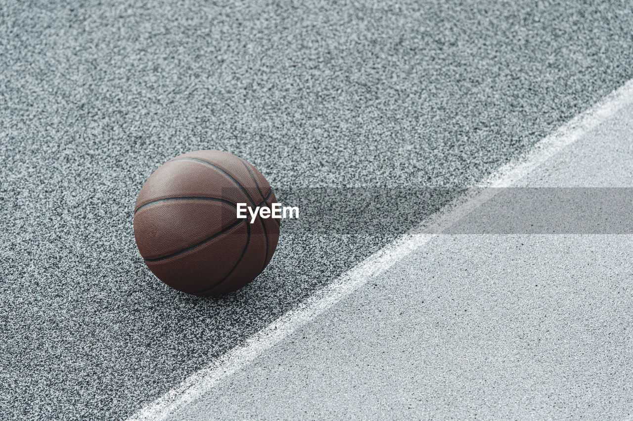 HIGH ANGLE VIEW OF BASKETBALL HOOP IN THE BACKGROUND