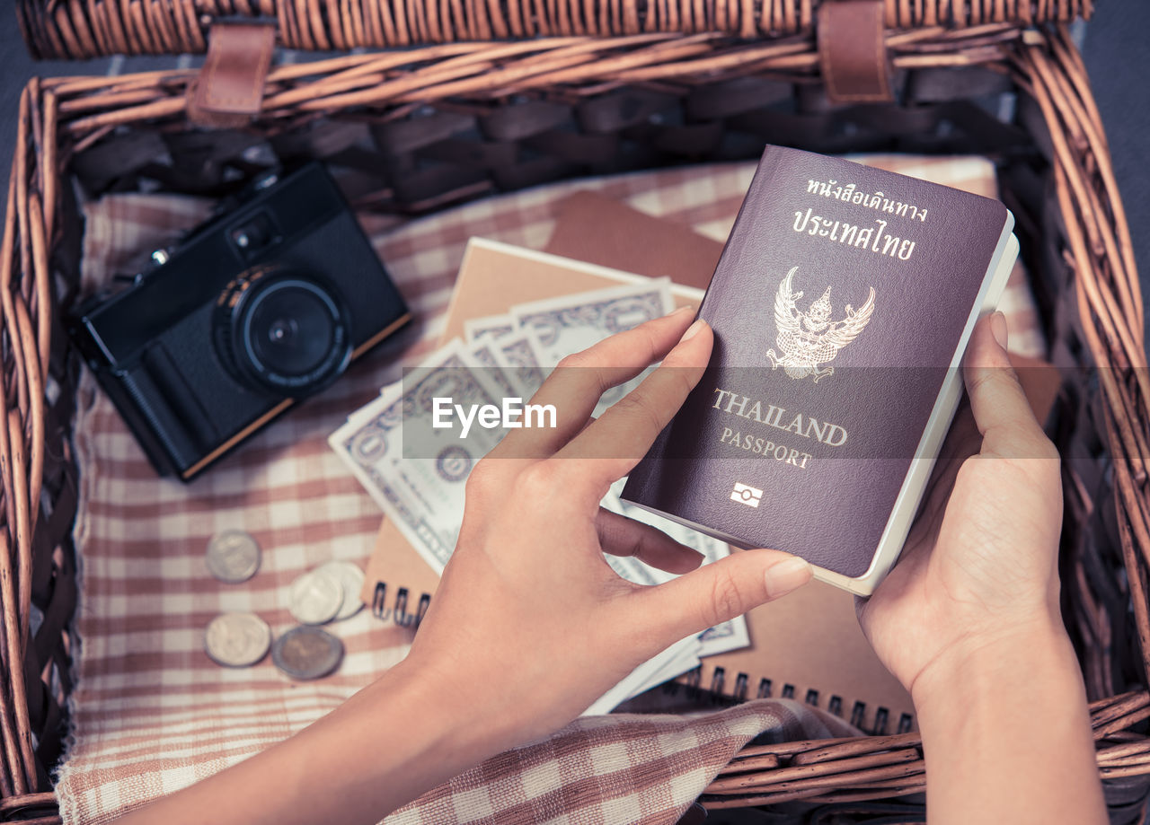 Midsection of woman holding passport