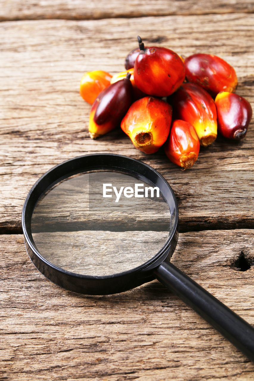 CLOSE-UP OF TOMATOES ON TABLE AGAINST ORANGE BACKGROUND