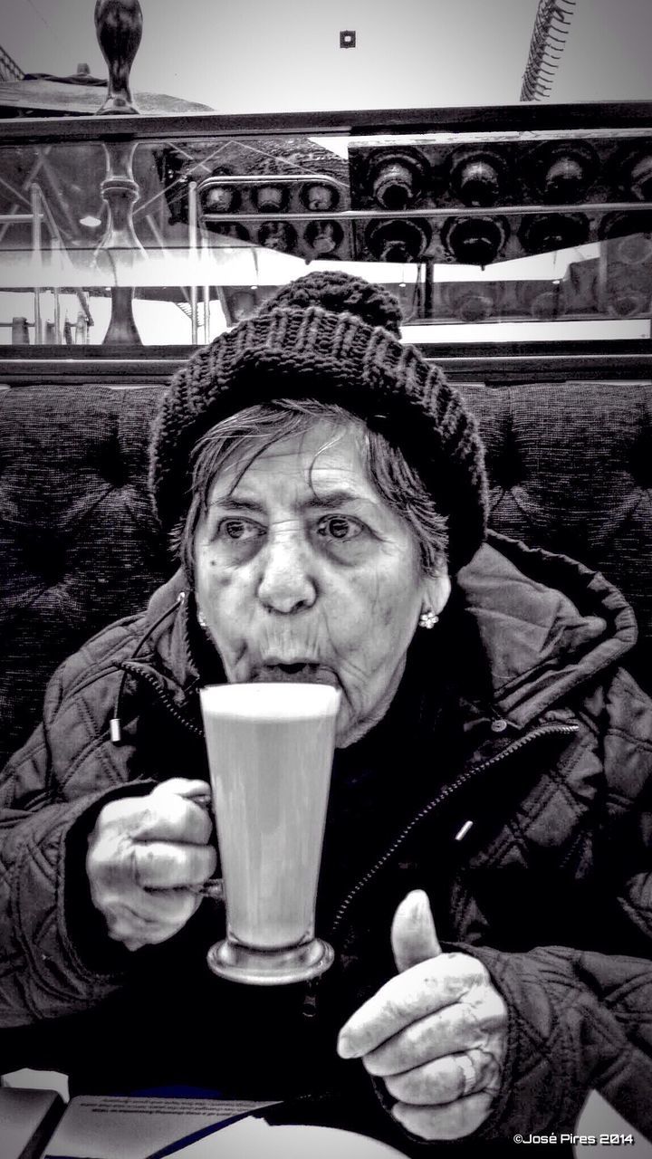 Senior woman drinking hot chocolate in cafe