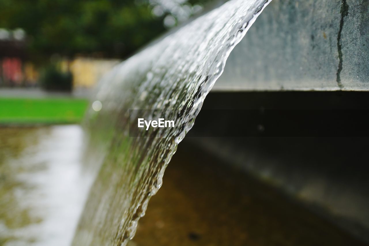 CLOSE-UP OF WATER SPLASHING ON ROCK