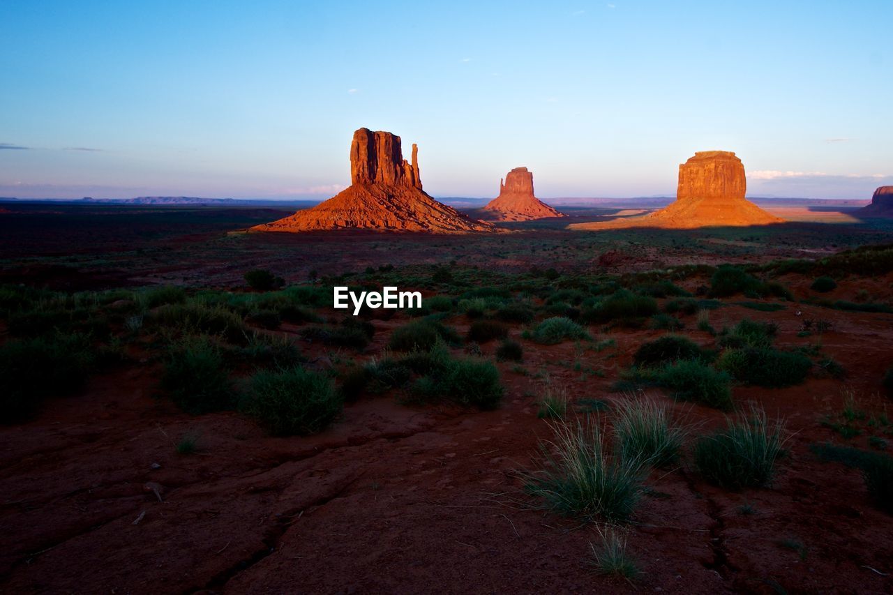 Scenic view of rock formations at monument valley during sunset