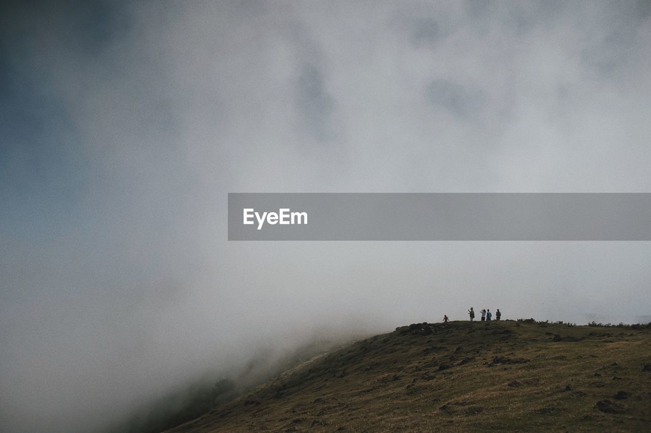 Distant view of people on mountains during foggy weather