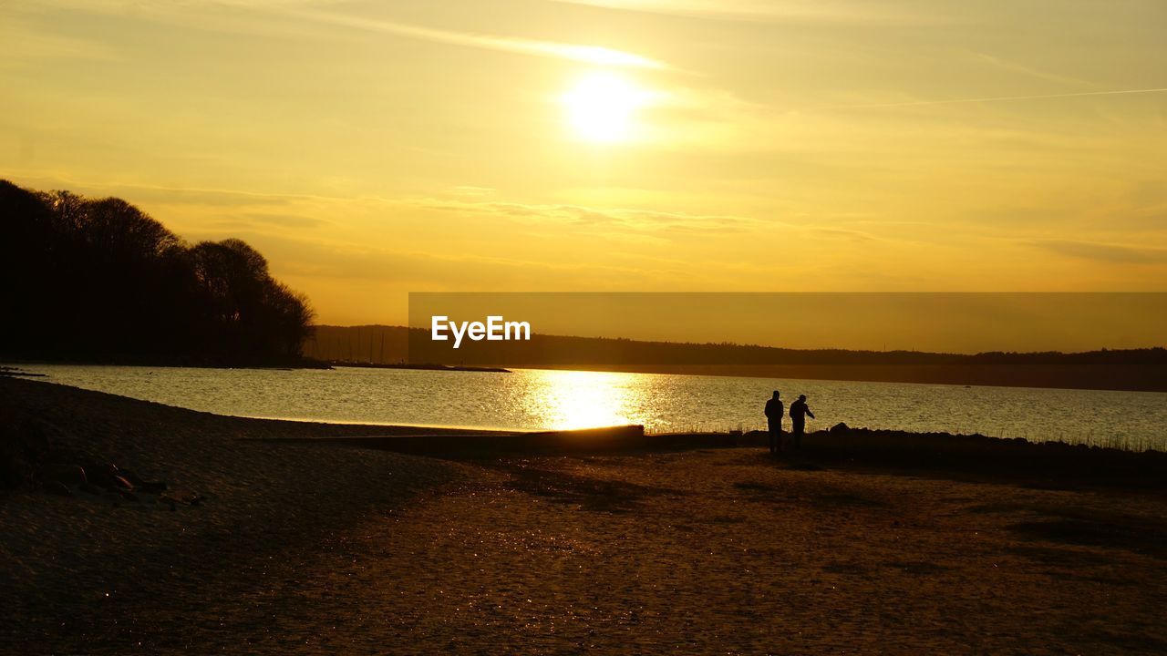 Scenic view of beach against sky during sunset