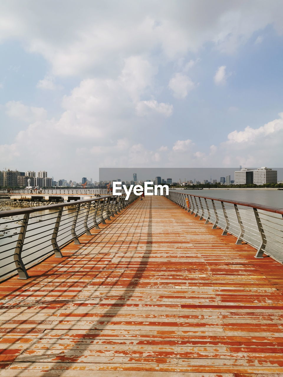 FOOTPATH LEADING TOWARDS BRIDGE AGAINST SKY