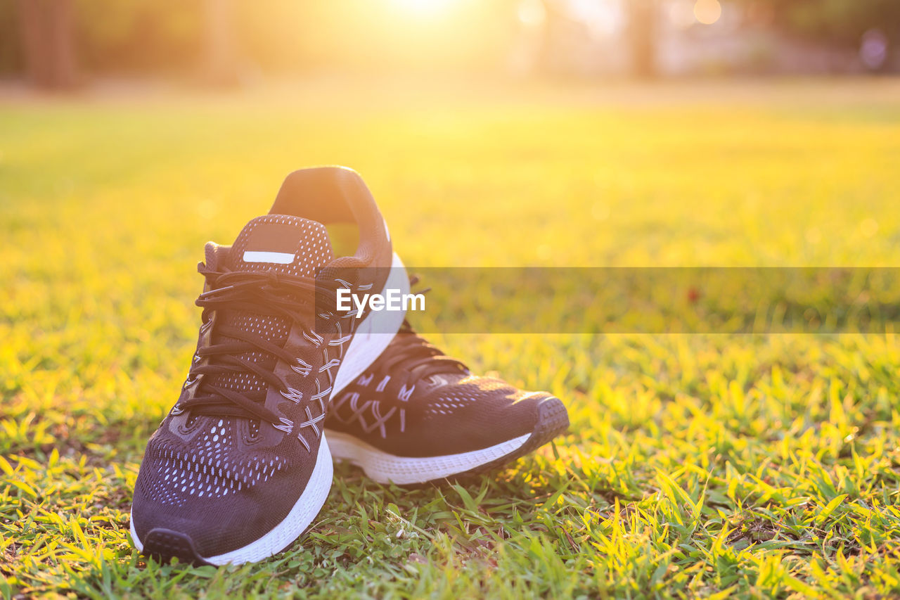 Close-up of sports shoes on field