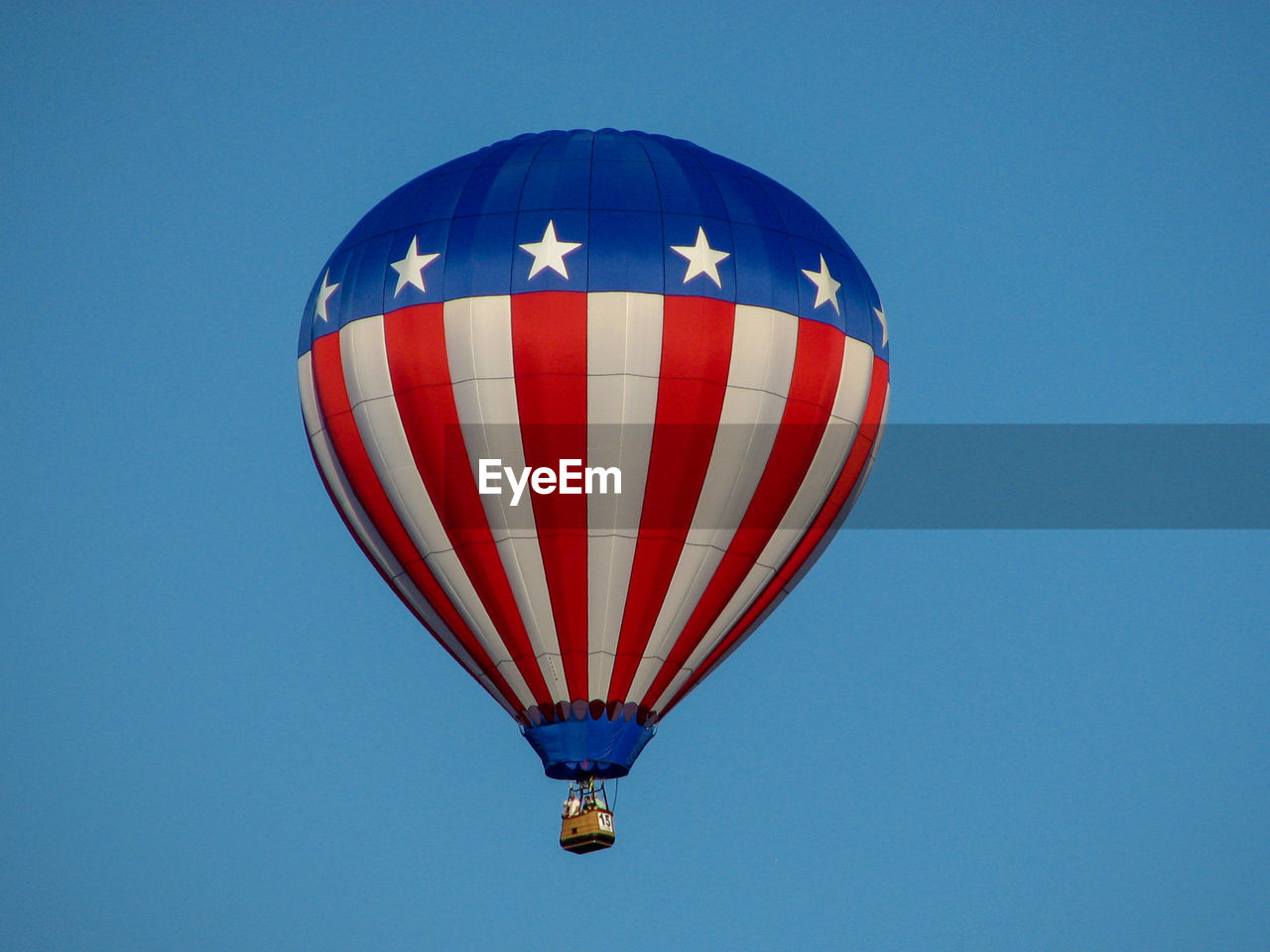 Low angle view of hot air balloon against clear blue sky