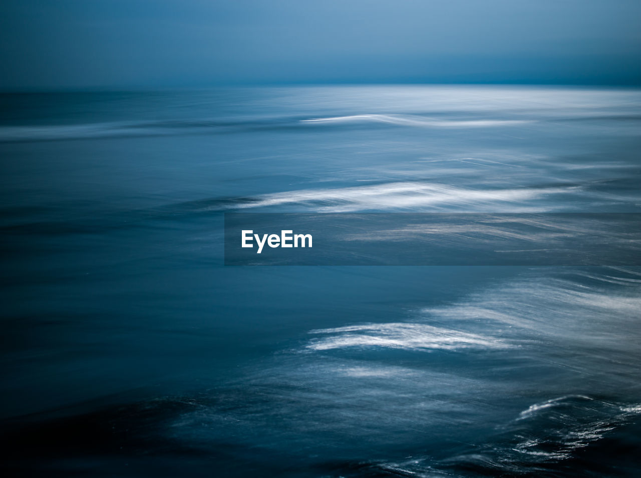 Aerial view of seascape against sky at dusk