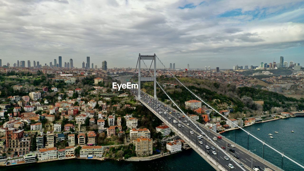 High angle view of 15-temmuz bridge and river amidst buildings in city against sky