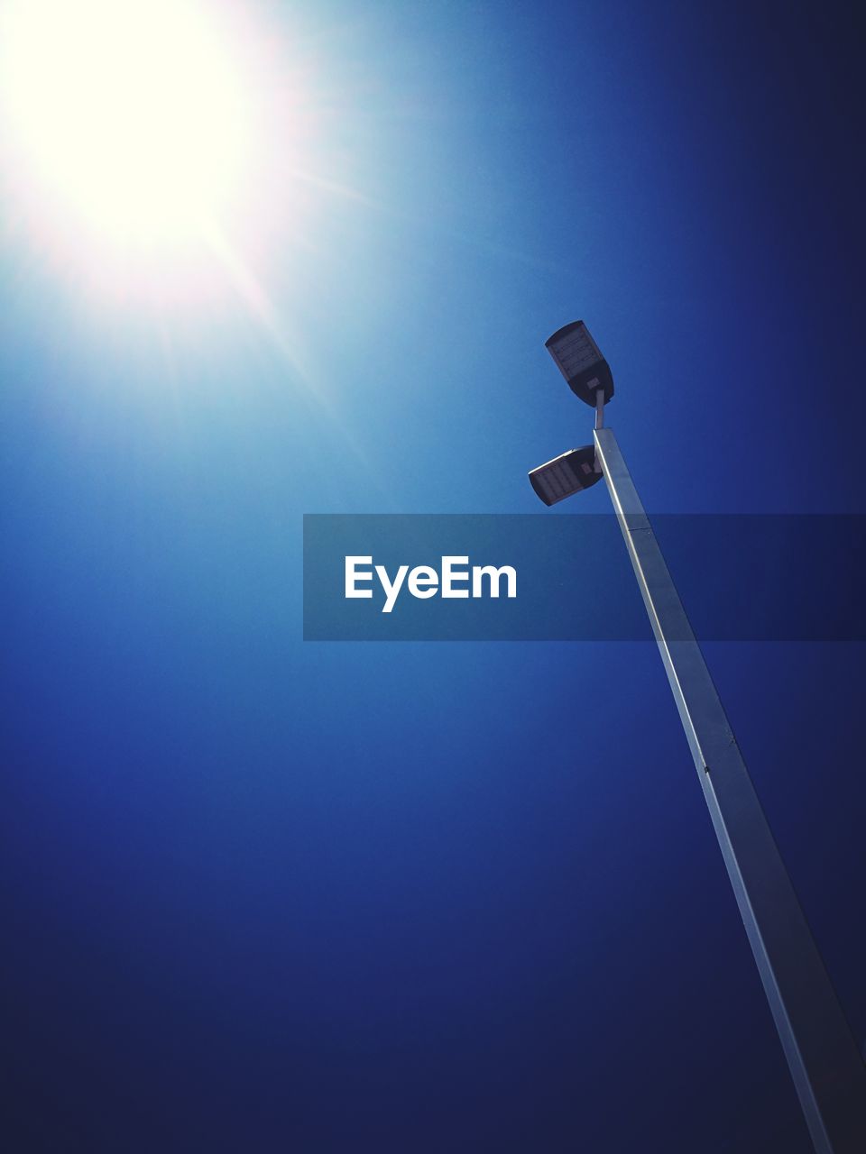 LOW ANGLE VIEW OF STREET LIGHT AGAINST BLUE SKY