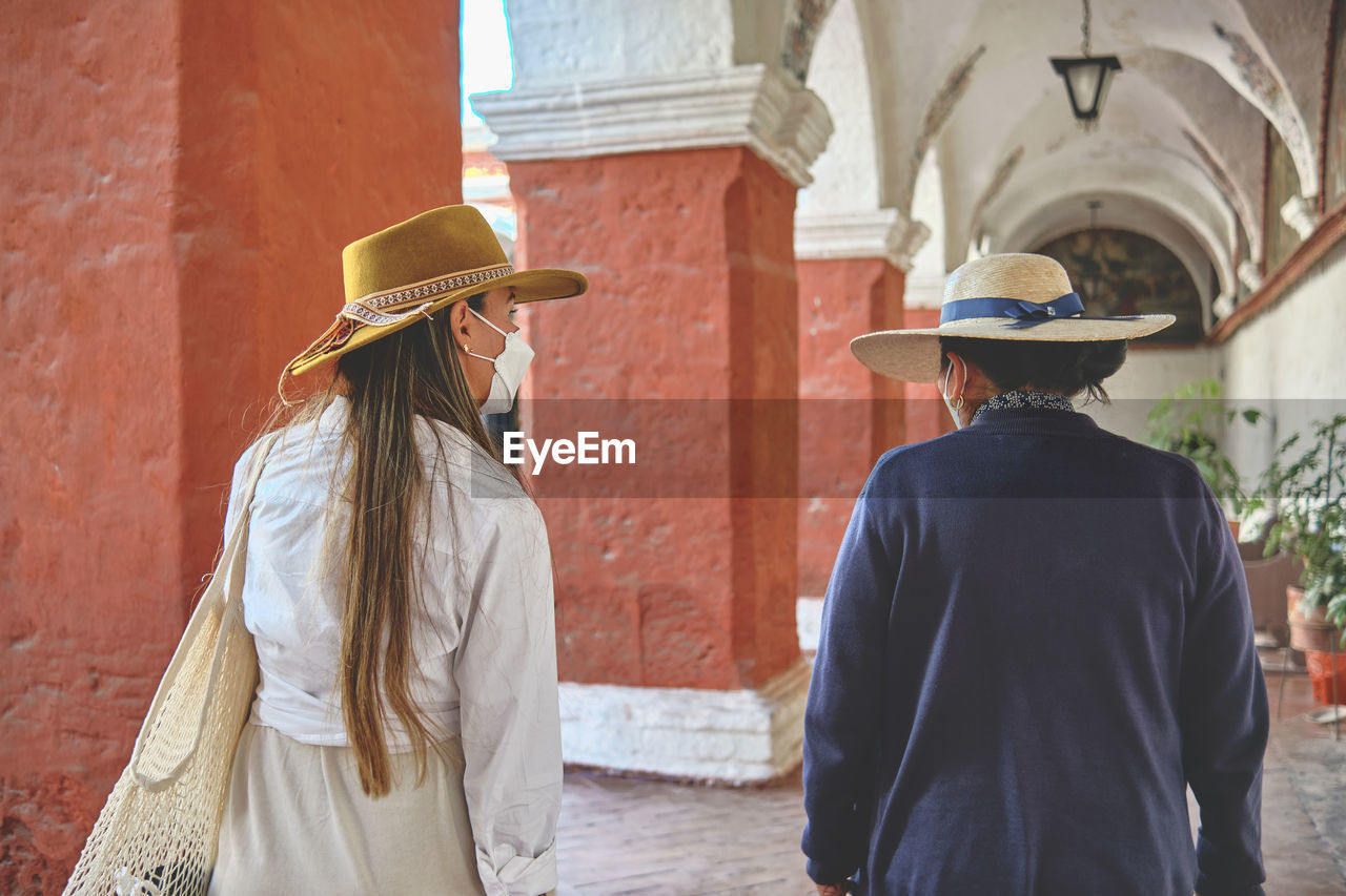 Tourists with a guide in inside the santa catalina monastery, arequipa, peru. exploring unesco