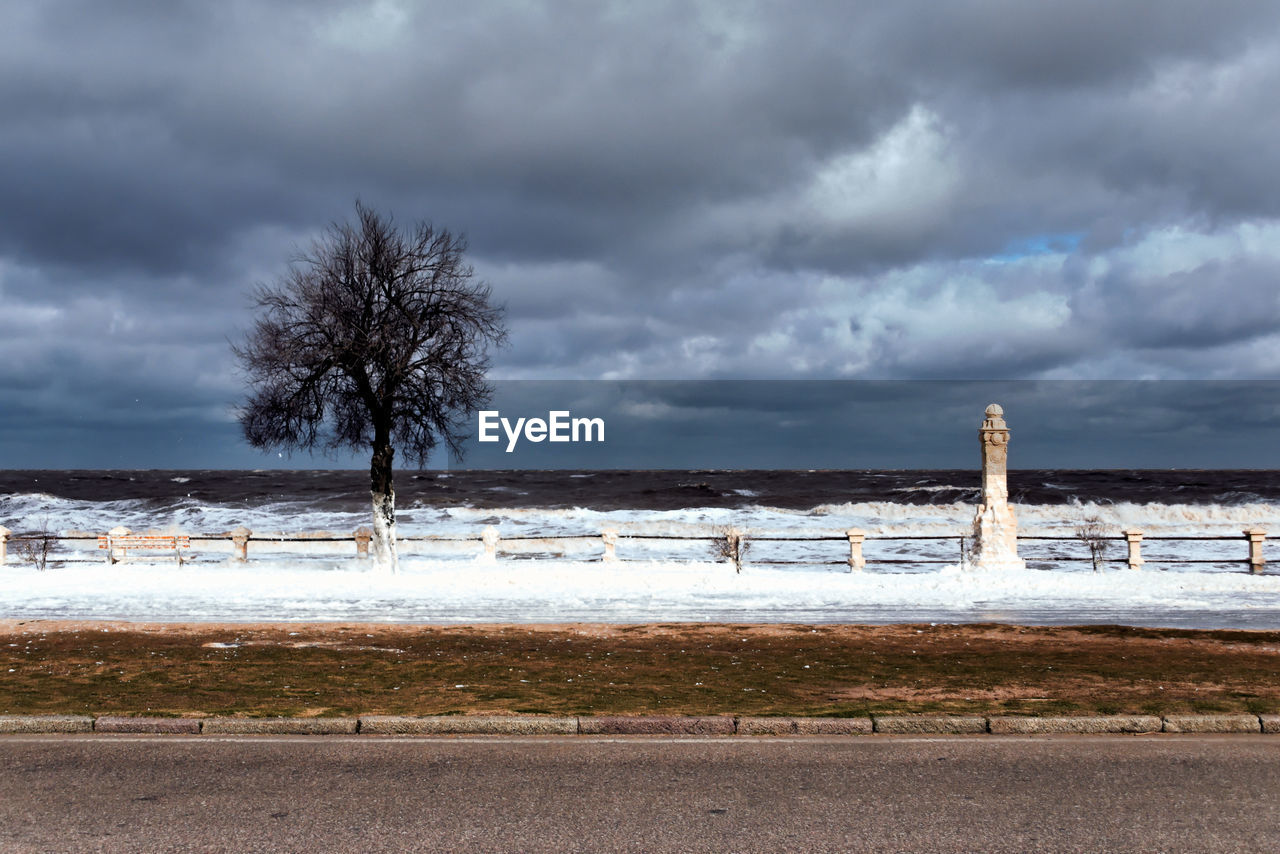 cloud, sky, shore, horizon, sea, land, coast, water, beach, storm, nature, ocean, environment, tree, scenics - nature, beauty in nature, plant, landscape, overcast, storm cloud, wind, snow, dramatic sky, no people, winter, architecture, wave, outdoors, sand, travel destinations, cold temperature, day, cloudscape, tower, tranquility, tranquil scene, coastline, non-urban scene, travel, built structure, morning, moody sky, road, body of water