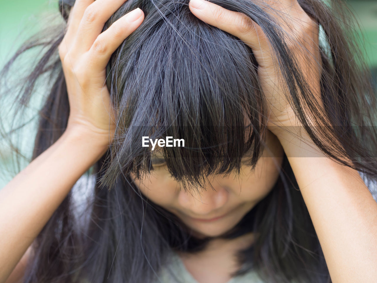 Close-up of depressed woman suffering from a headache