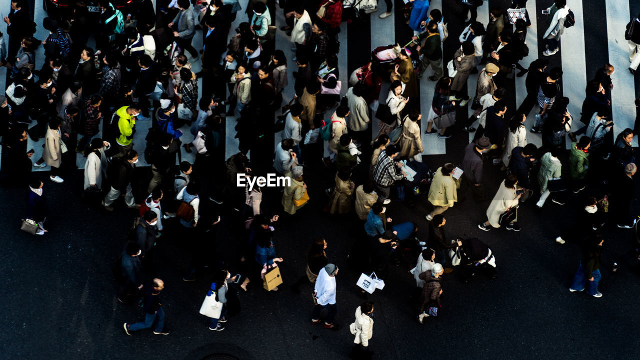 High angle view of people walking on road in city