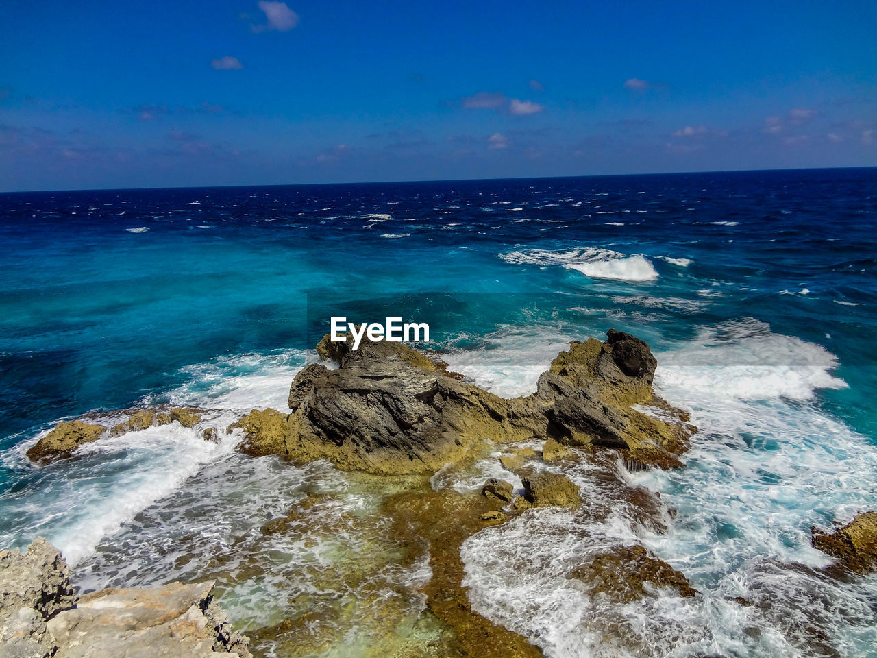 Scenic view of sea against blue sky