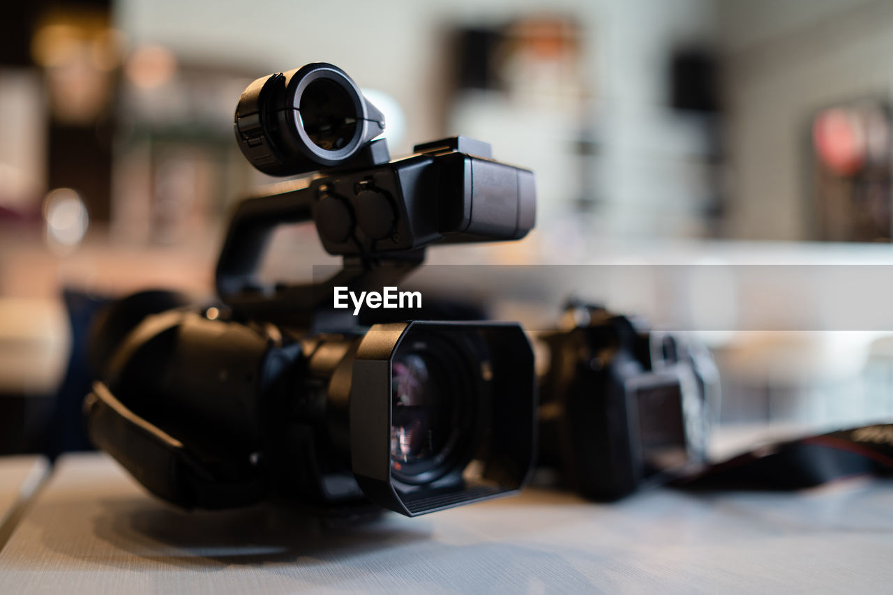 CLOSE-UP OF CAMERA ON TABLE IN CAFE