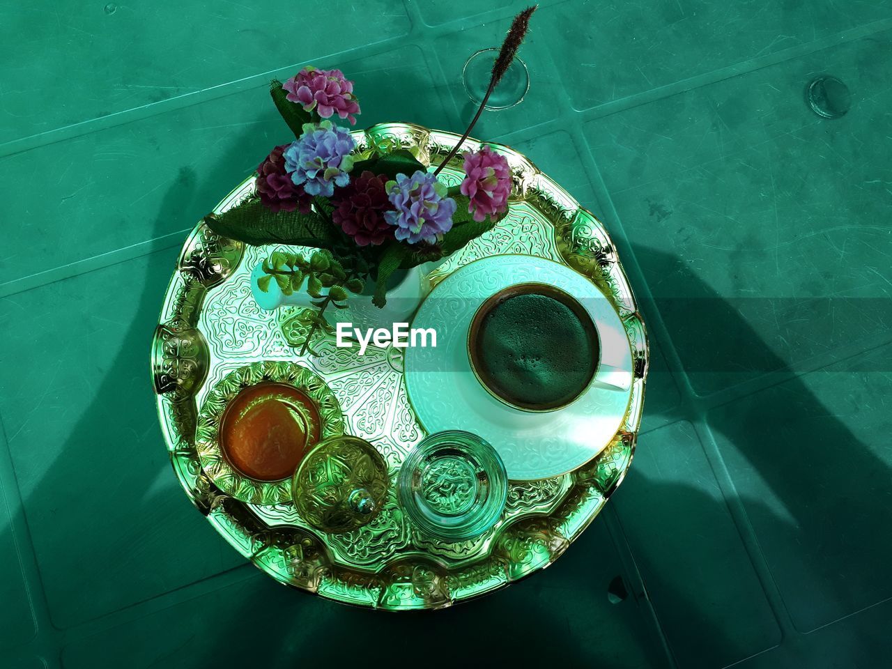 HIGH ANGLE VIEW OF ROSE ON GLASS TABLE