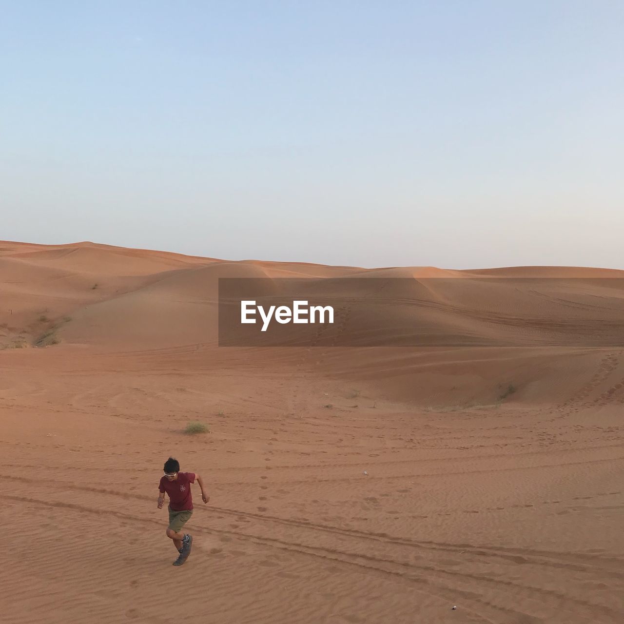 MAN IN DESERT AGAINST SKY