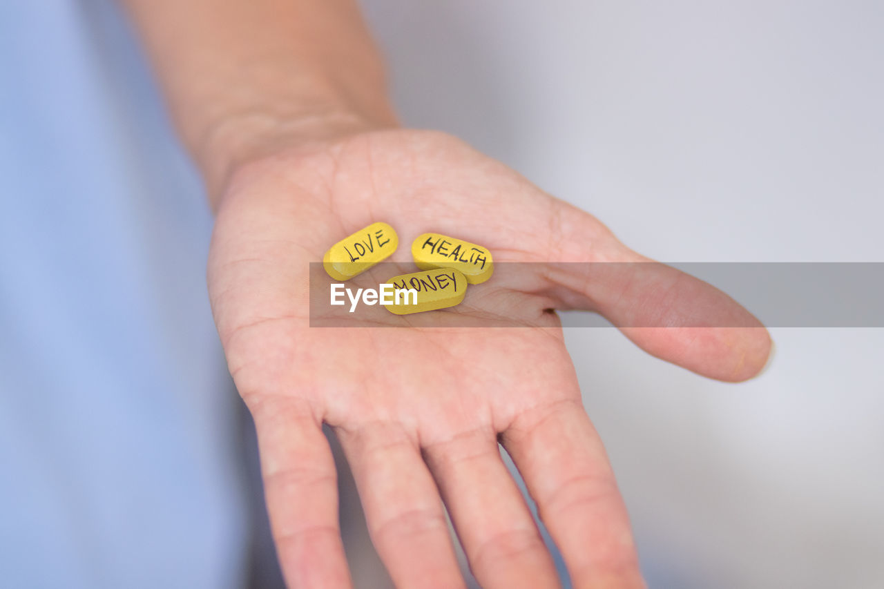 Cropped hand of woman holding pills