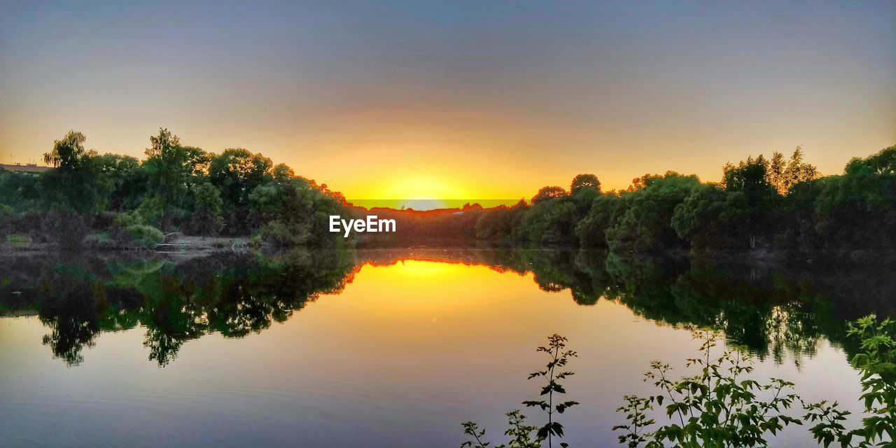 SCENIC VIEW OF LAKE DURING SUNSET