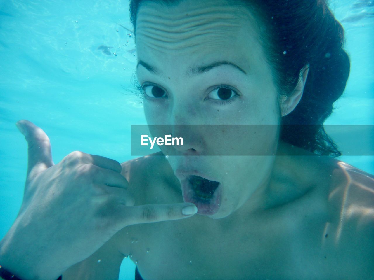 Close-up of woman swimming underwater