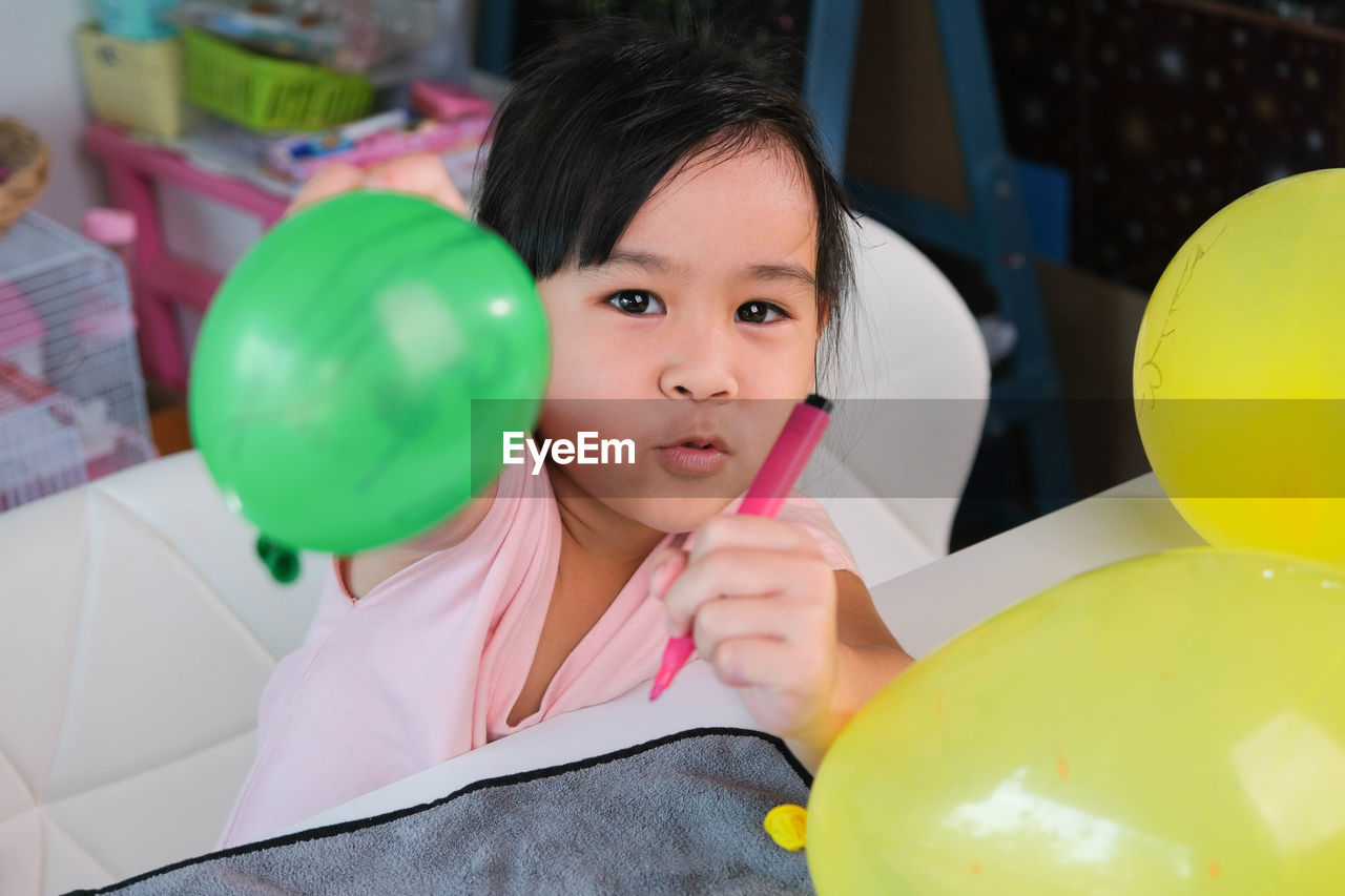 portrait of young woman playing with toys at home