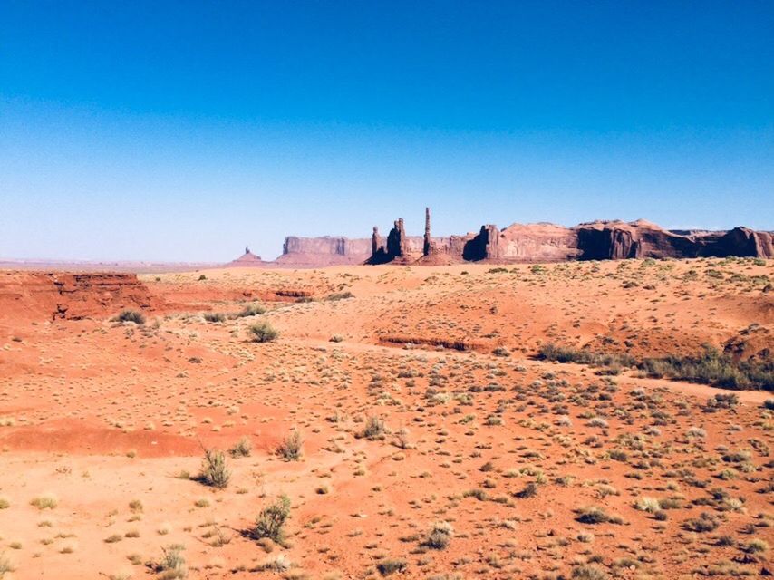 ROCK FORMATIONS ON LANDSCAPE AGAINST BLUE SKY