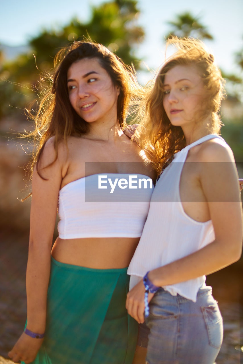 Friends standing at beach