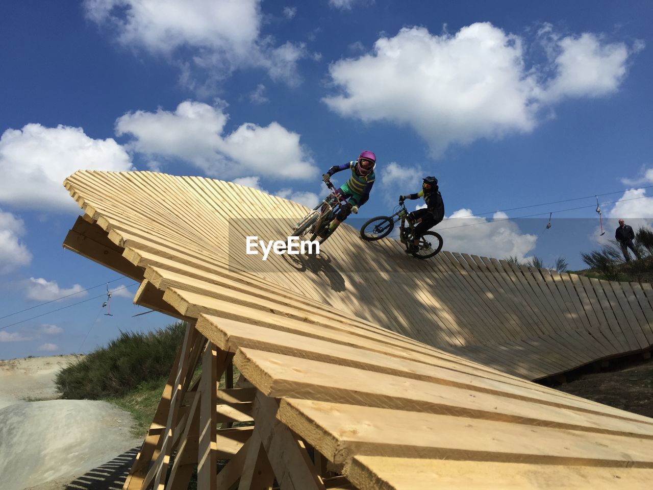 Man riding mountainbike against sky