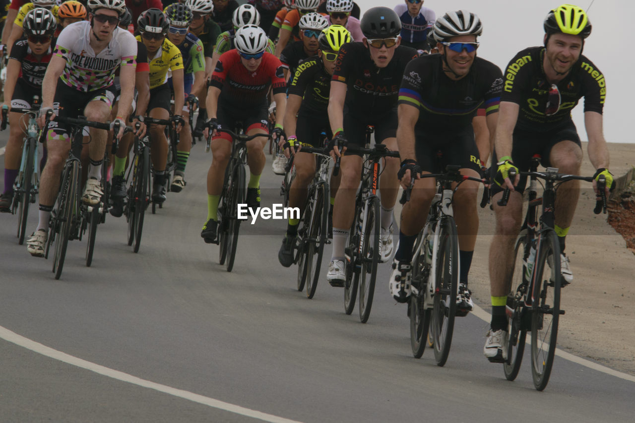 PANORAMIC VIEW OF PEOPLE WITH BICYCLE