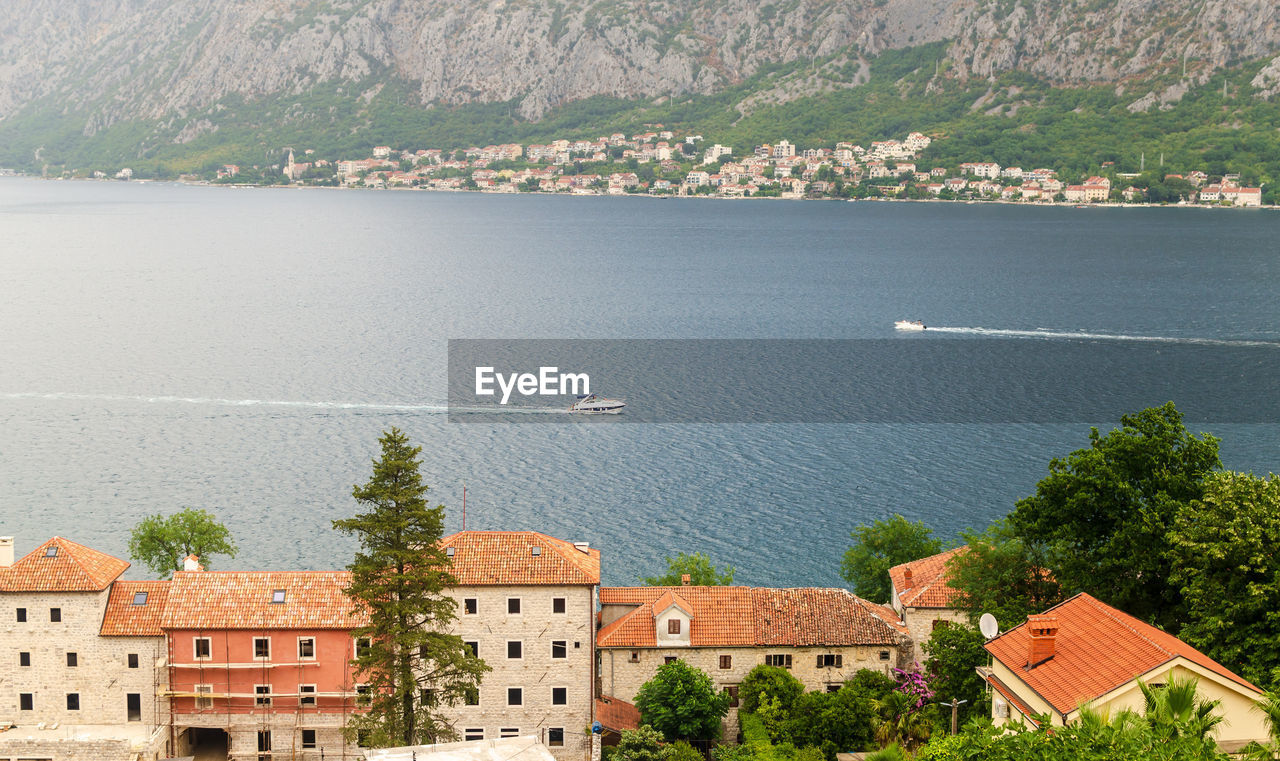 Impressive aerial view to the part of kotor bay - red roofs, boats, sea and the town of dobrota