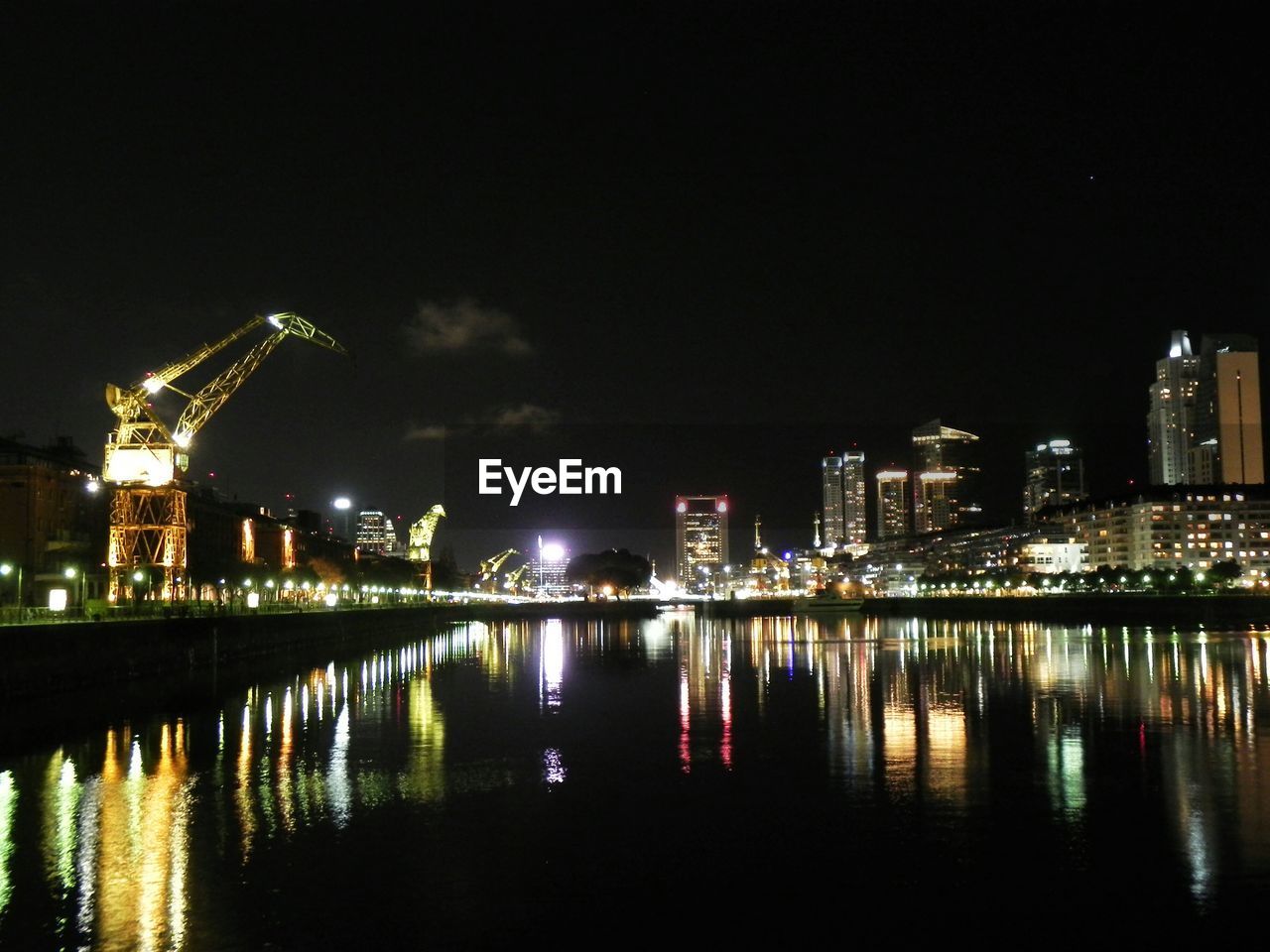 VIEW OF ILLUMINATED CITYSCAPE AT NIGHT