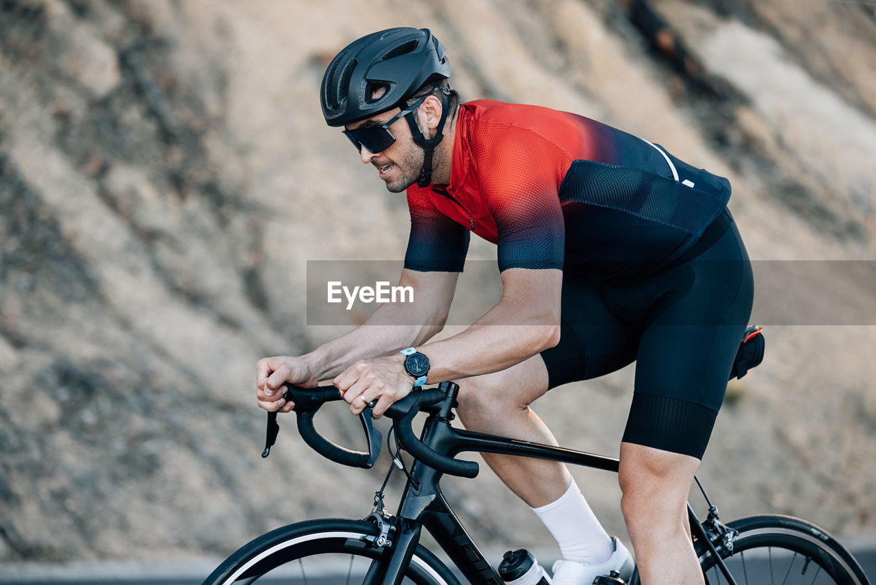 man riding bicycle on road