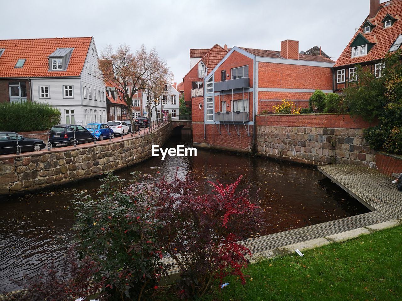 Canal amidst buildings against sky