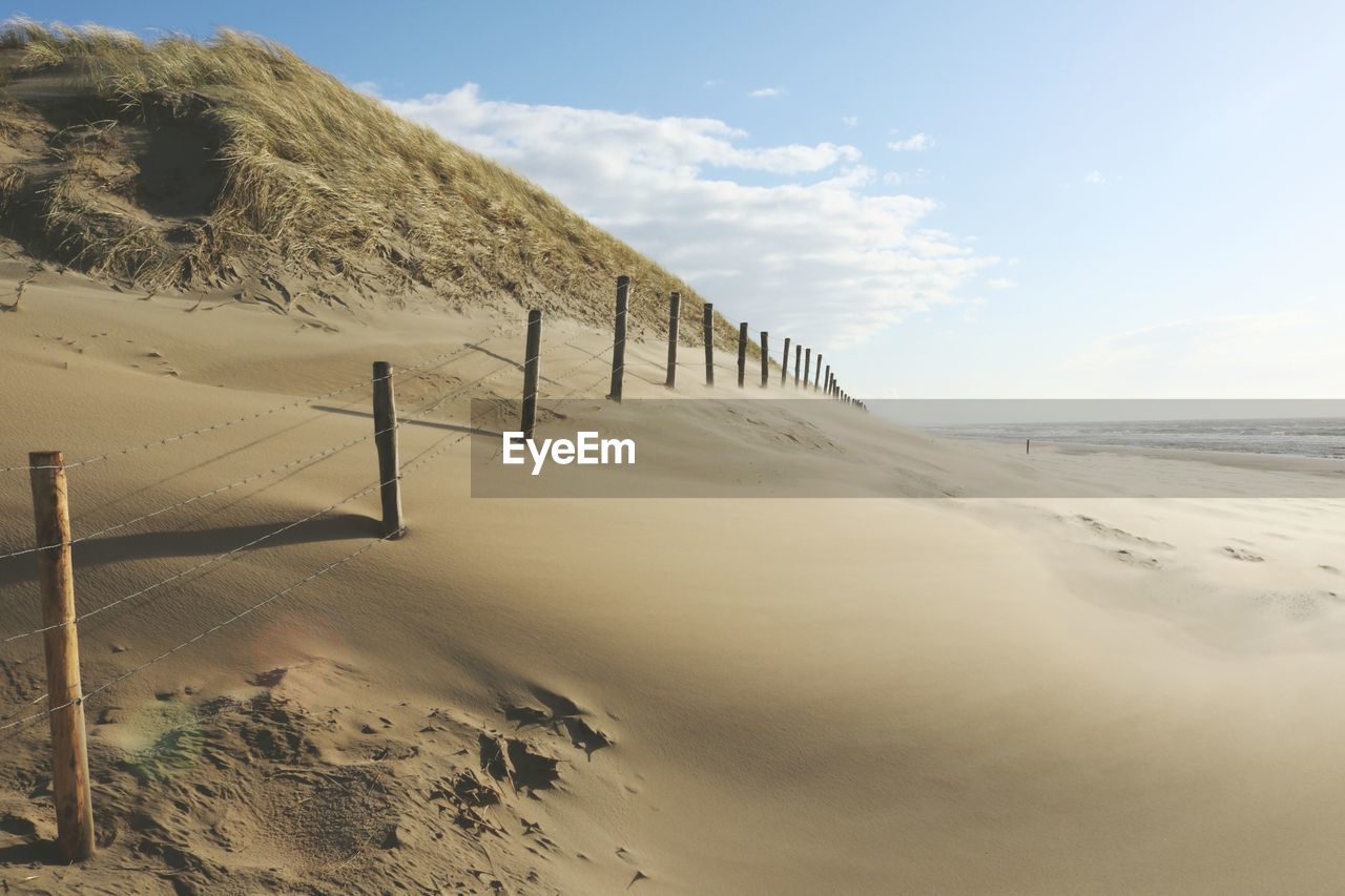 Fence on sand at beach