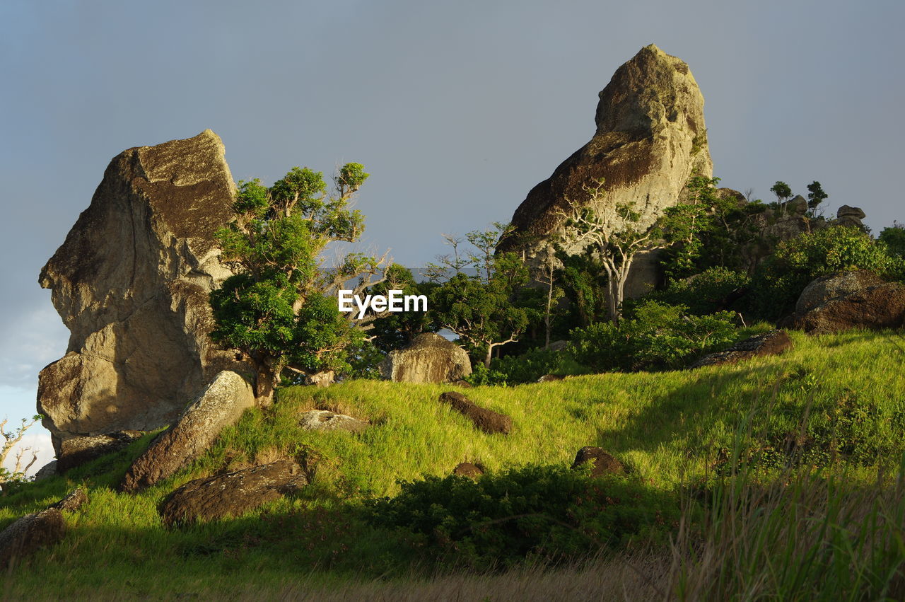 Rock formations on landscape against sky