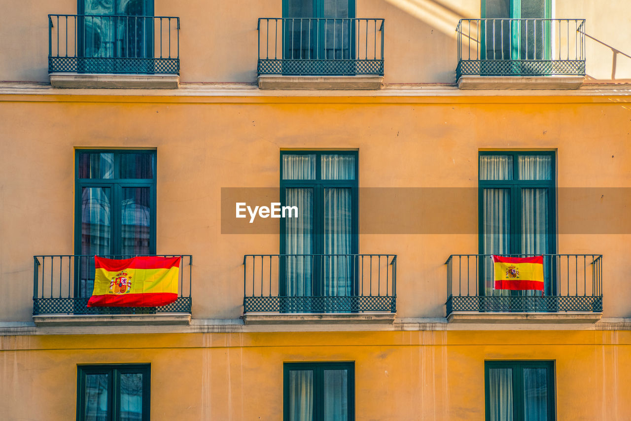 Facade with windows and spanish flags.