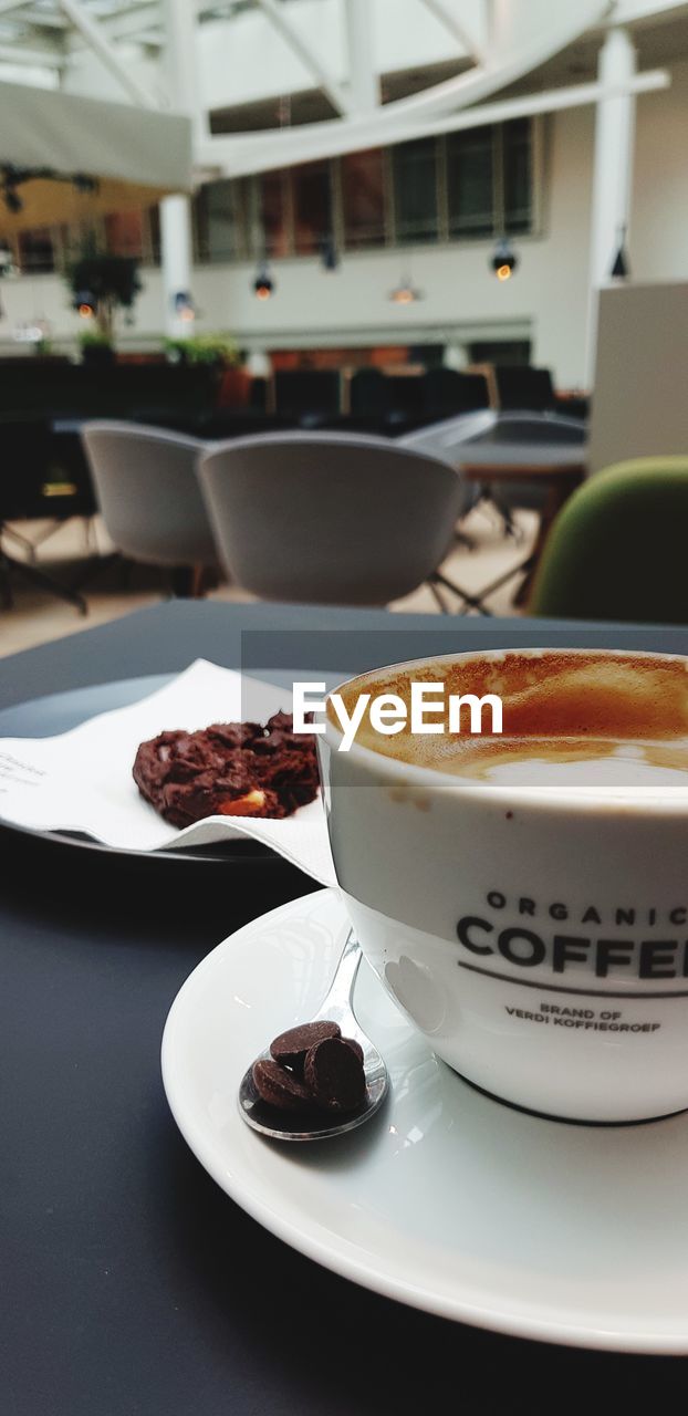 CLOSE-UP OF COFFEE SERVED ON TABLE AT CAFE