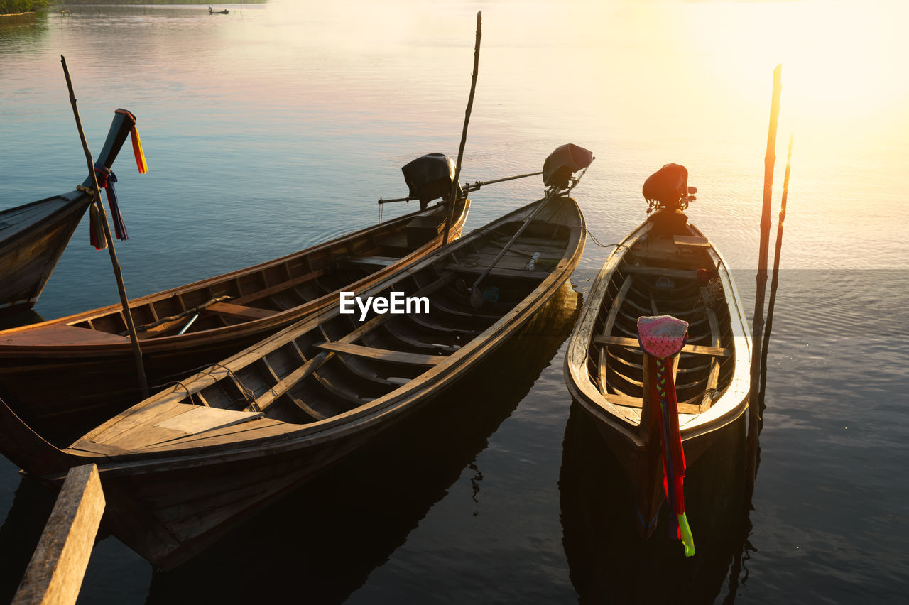 REAR VIEW OF MAN WITH BOAT IN SEA